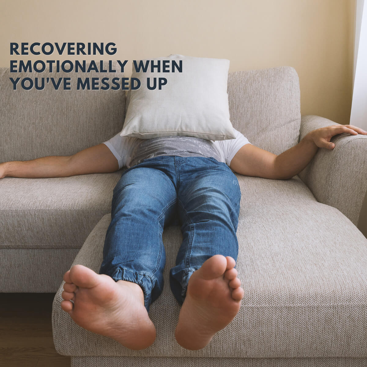 recovering emotionally on sofa with pillow over face